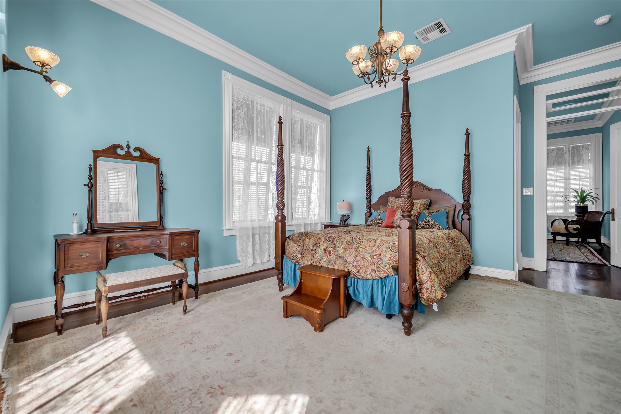 926 Winnie Street Galveston, TX 77550 - Photo 27 of 49 a bedroom with a bed and a chandelier