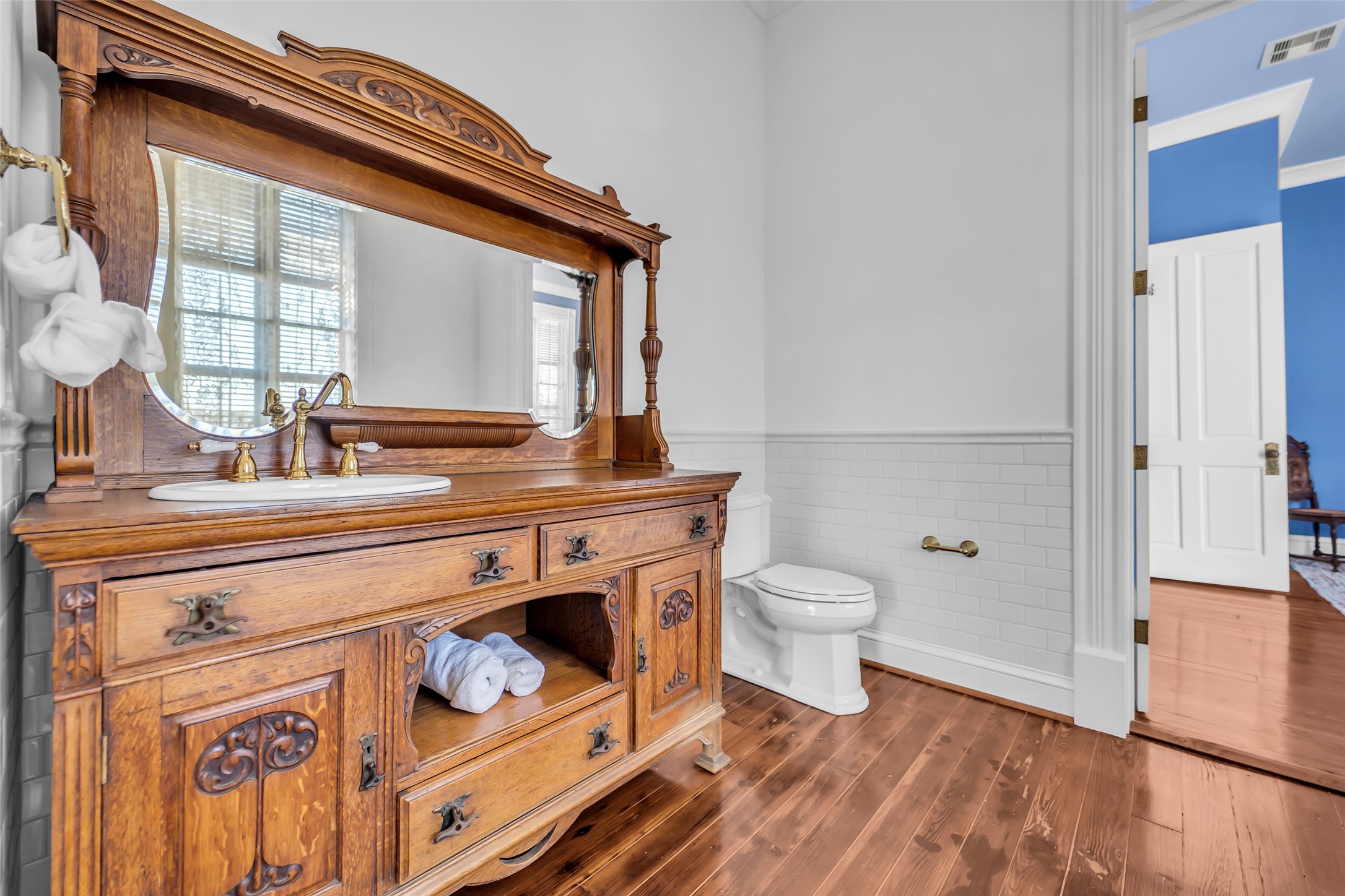 926 Winnie Street Galveston, TX 77550 - Photo 31 of 49 a bathroom with a toilet a sink and a mirror