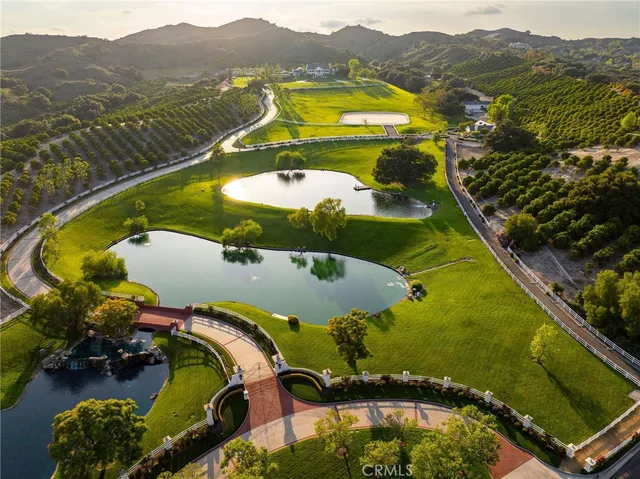 an aerial view of a swimming pool with a yard and mountain view