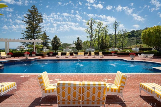 a view of swimming pool with outdoor seating