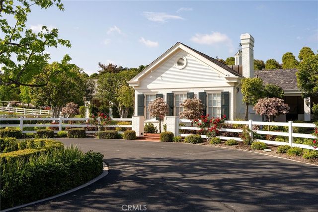 a front view of a house with sitting area