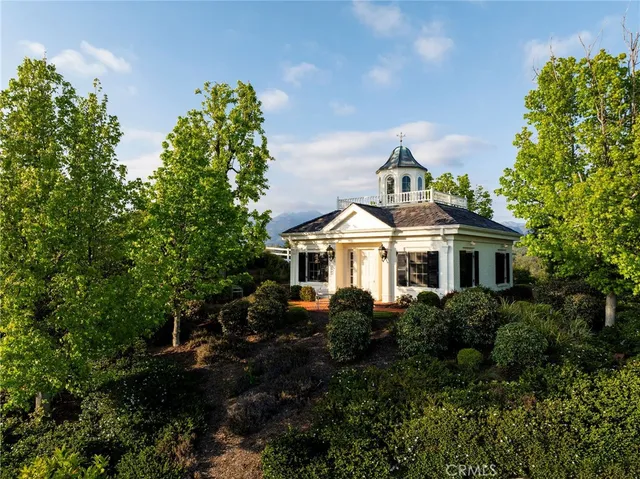 a front view of a house with a yard and potted plants