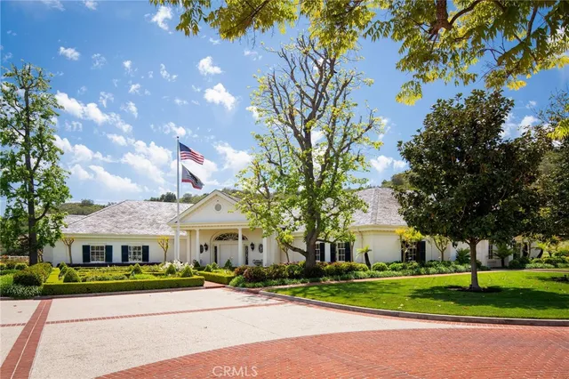 a front view of house with yard and green space