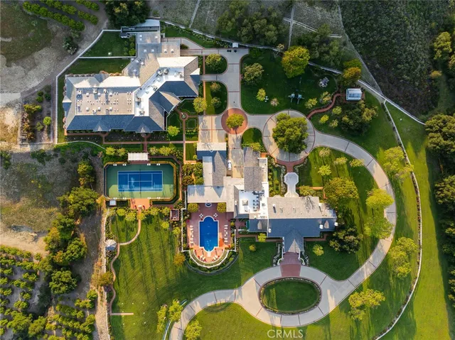 an aerial view of residential house with outdoor space and swimming pool