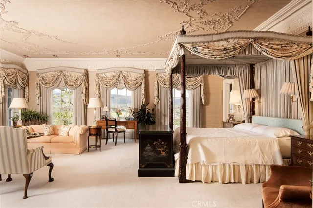 a bedroom with a bed and a chandelier