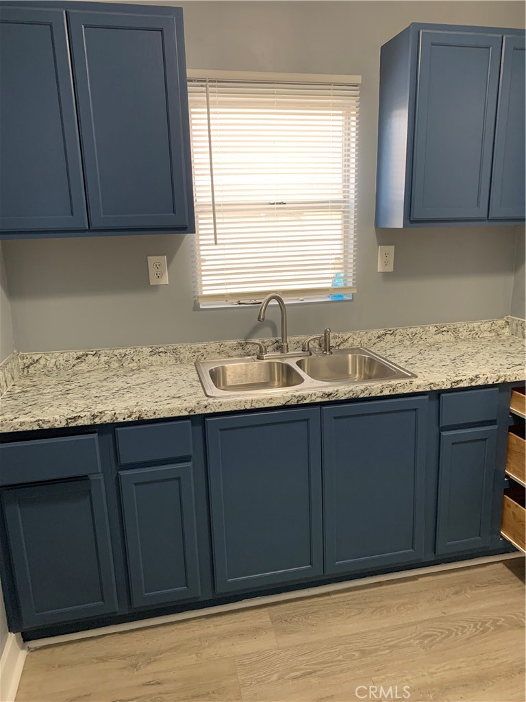a kitchen with granite countertop cabinets and window