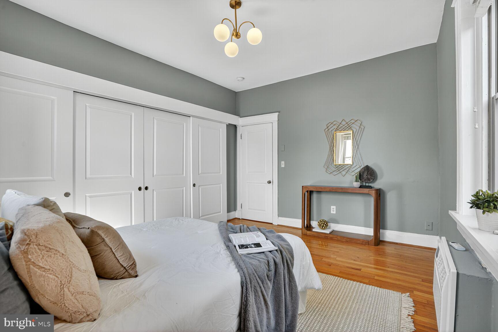 2010 Kalorama Road Northwest, Unit 506 Washington, DC 20009 - Photo 15 of 22 a bedroom with a bed and a chandelier