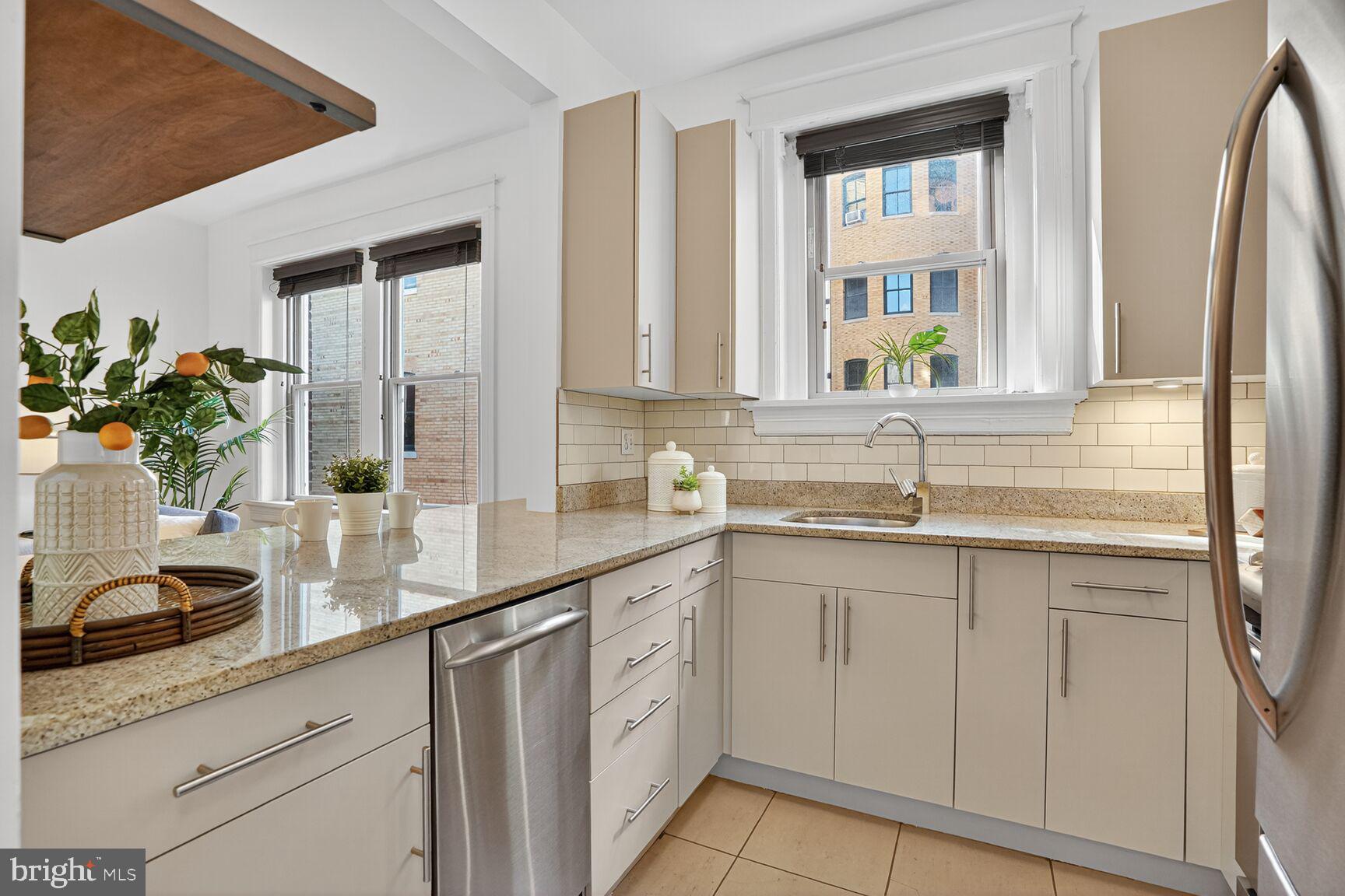 2010 Kalorama Road Northwest, Unit 506 Washington, DC 20009 - Photo 8 of 22 a kitchen with white cabinets and sink