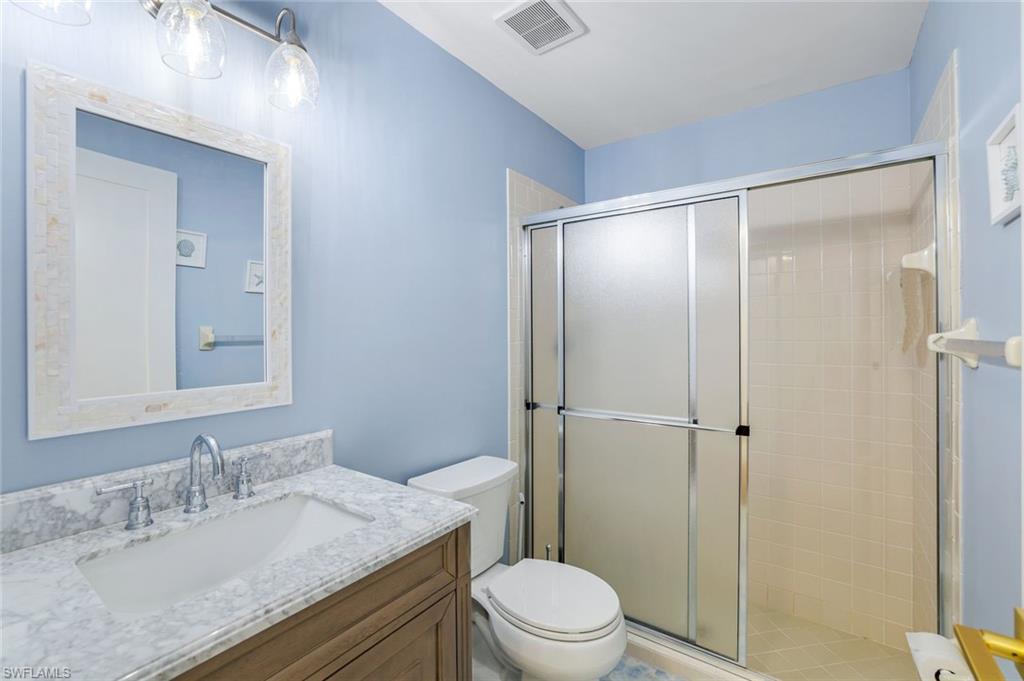 555 Augusta Boulevard, Unit 31 Naples, FL 34113 - Photo 13 of 17 a bathroom with a granite countertop sink toilet and shower