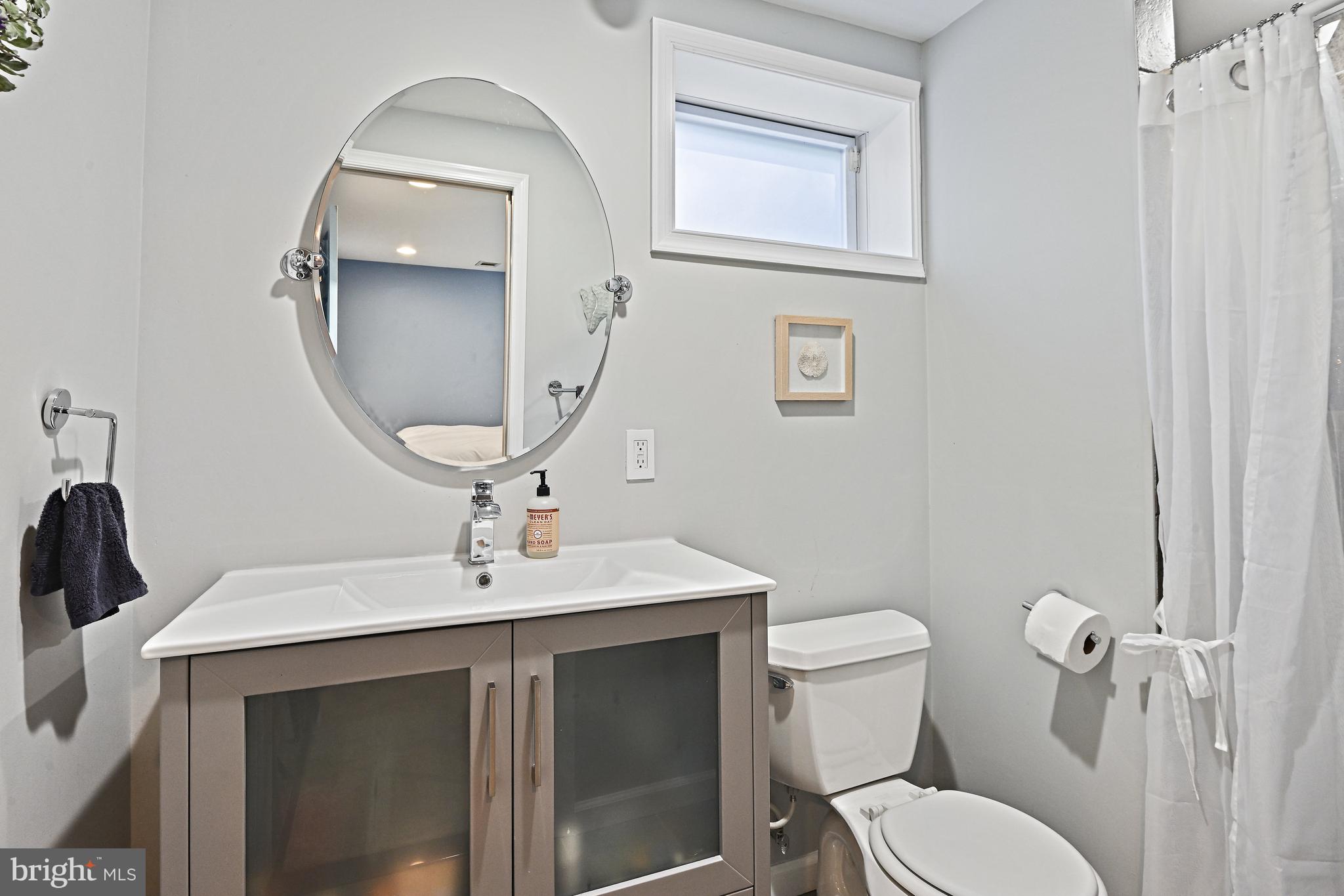 6602 Jerry Place McLean, VA 22101 - Photo 19 of 28 a bathroom with a sink toilet and mirror