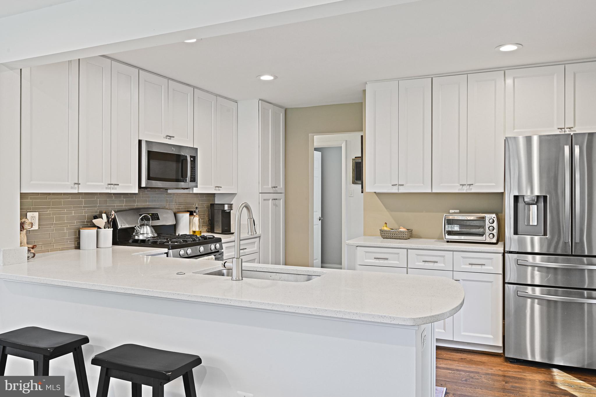 6602 Jerry Place McLean, VA 22101 - Photo 6 of 28 a kitchen with stainless steel appliances a refrigerator stove microwave and cabinets