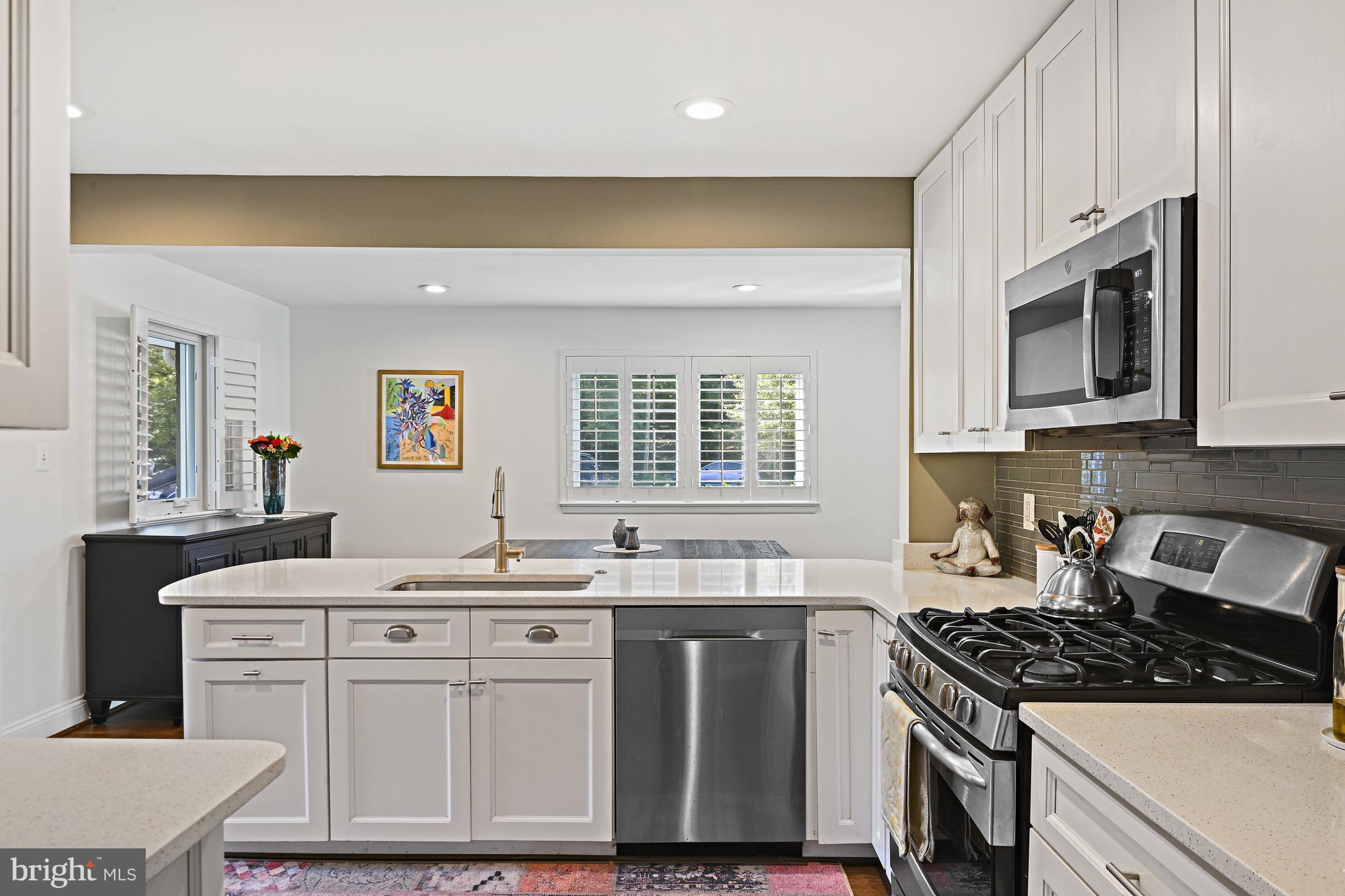 6602 Jerry Place McLean, VA 22101 - Photo 7 of 28 a kitchen with stainless steel appliances granite countertop a stove a sink and a microwave