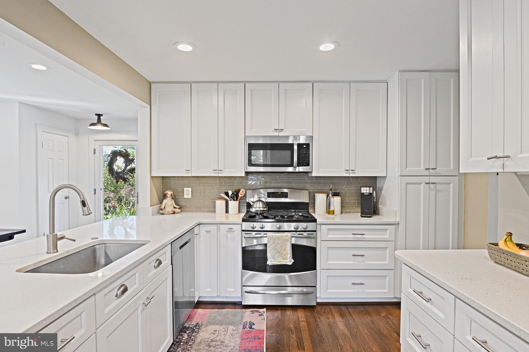 6602 Jerry Place McLean, VA 22101 - Photo 8 of 28 a kitchen with white cabinets stainless steel appliances and sink