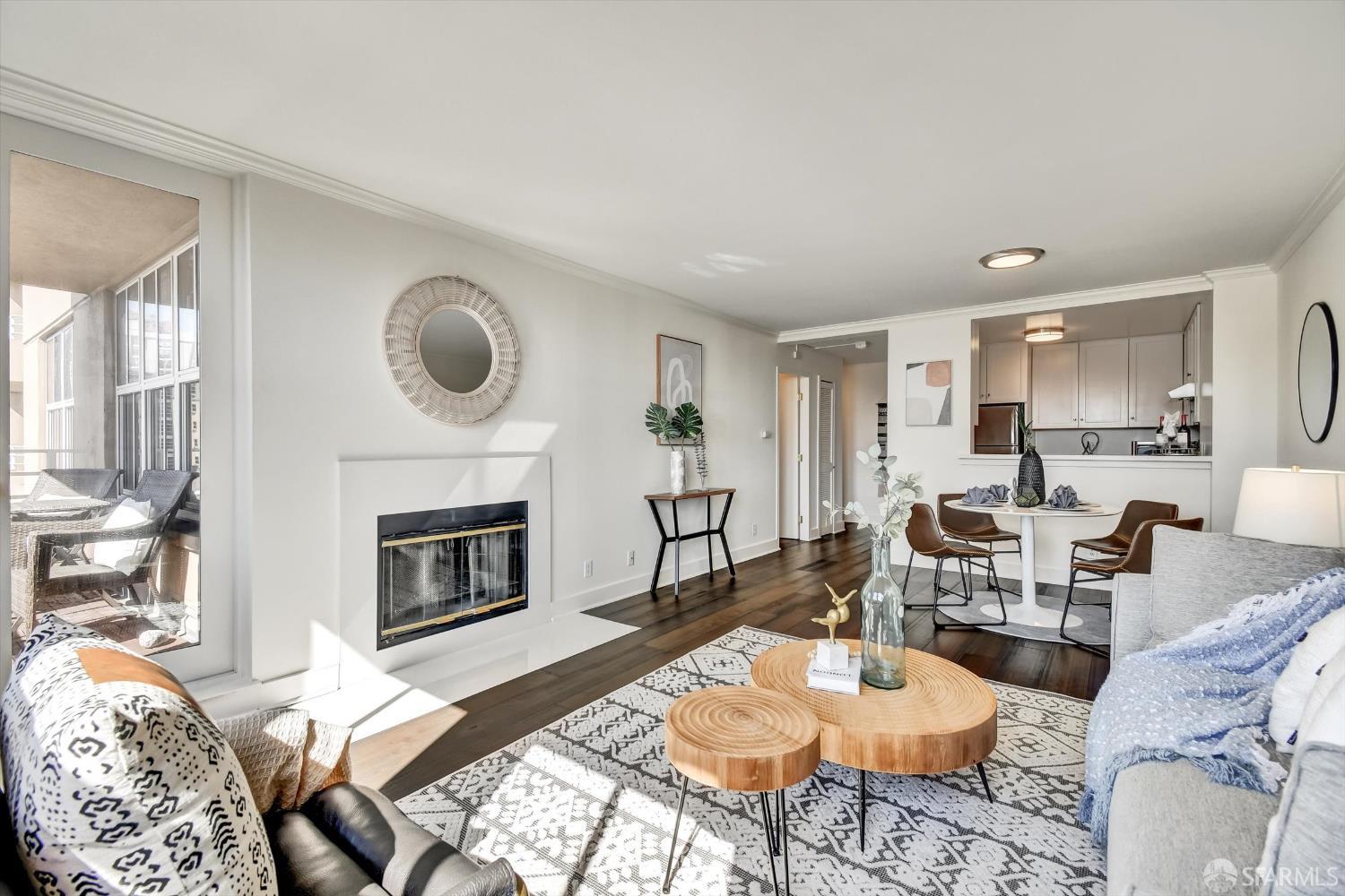 a living room with furniture a fireplace and a large window