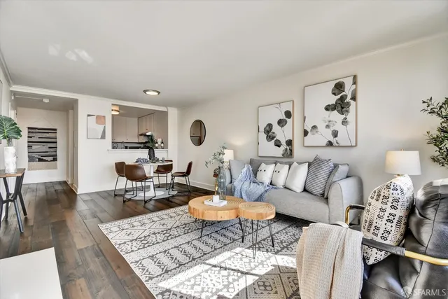 a living room with furniture and view of kitchen