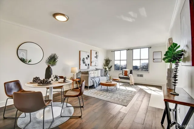 a living room with fireplace furniture and a potted plant