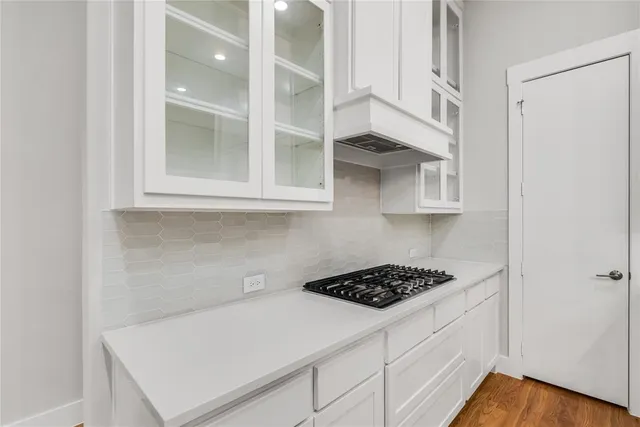 a kitchen with stainless steel appliances white cabinets and a stove