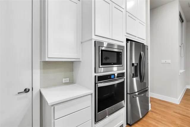 a kitchen with stainless steel appliances granite countertop a refrigerator and a stove