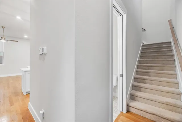 a view of a hallway with wooden floor and entryway
