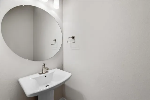 a bathroom with a sink and mirror