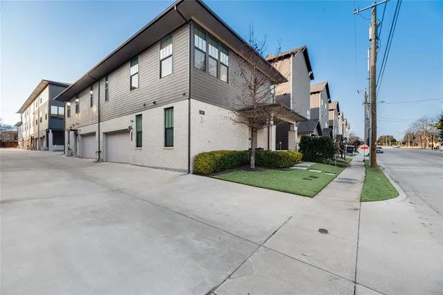 a view of a white house with a yard