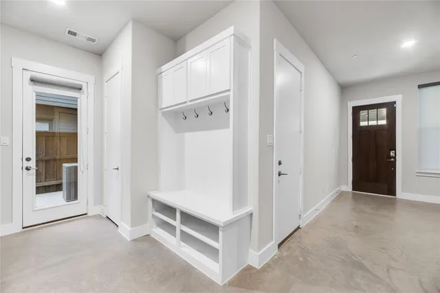 a view of a hallway to rooms