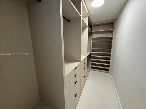 a view of kitchen cabinets and refrigerator