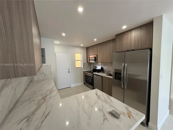 a view of hallway with a bathroom