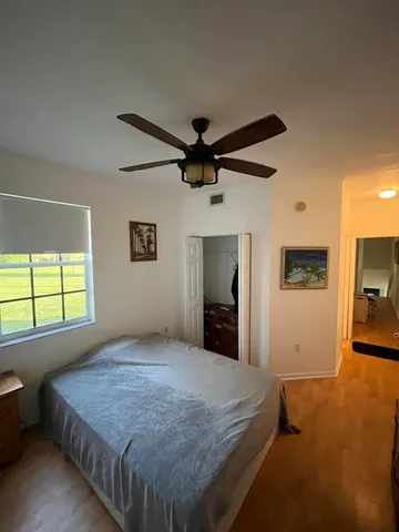 a bedroom with a bed and a flat tv screen on the dresser