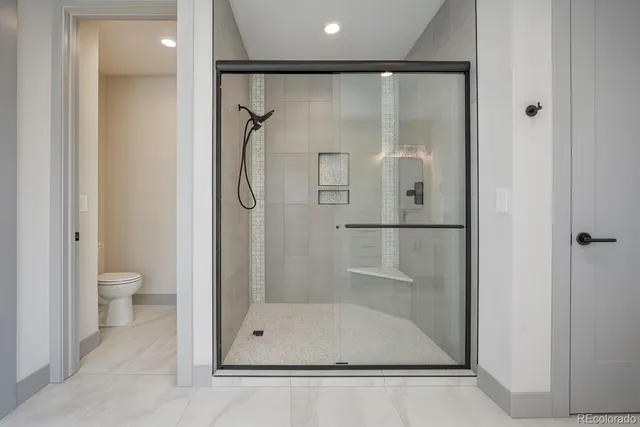 a bathroom with a glass shower door