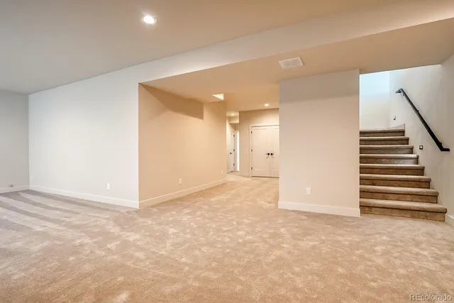 a view of an empty room with stairs
