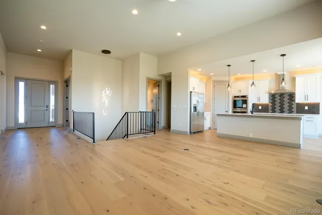 a view of a kitchen with a refrigerator and a stove
