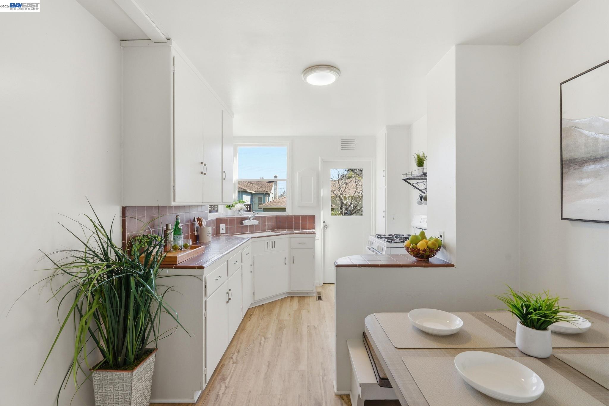 1368 Rose Street Berkeley, CA 94702 - Photo 6 of 21 a living room with kitchen island furniture and a potted plant