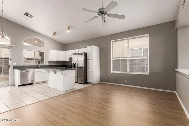 a view of kitchen with stainless steel appliances kitchen island hardwood floor sink stove and wooden cabinets