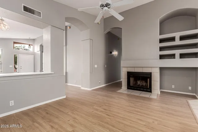 a view of a livingroom with a fireplace and window
