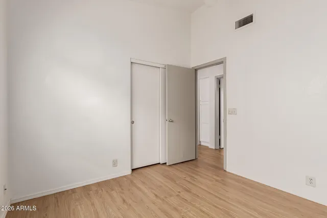 a view of an empty room with wooden floor