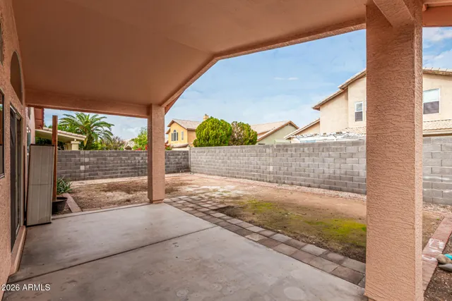 a view of a porch with a floor to ceiling window next to a yard