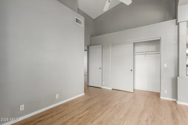 a view of an empty room with wooden floor