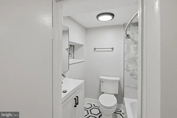 a bathroom with a toilet a sink and a mirror