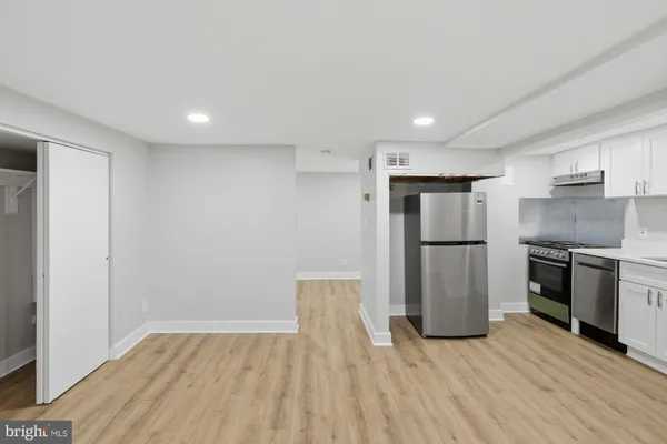 a kitchen with a refrigerator and a stove top oven
