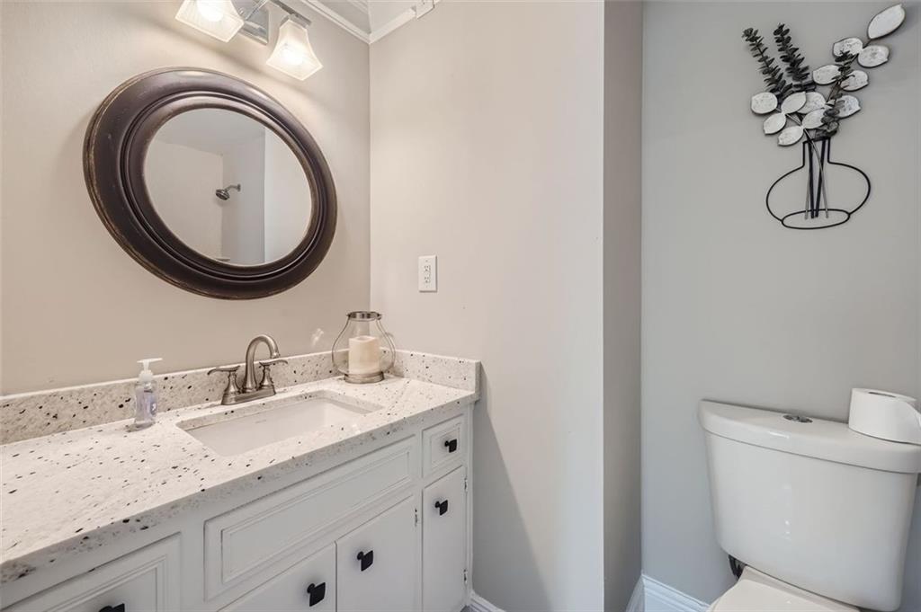 7575 Ball Mill Road Northeast Atlanta, GA 30350 - Photo 28 of 36 a bathroom with a granite countertop toilet sink mirror and vanity