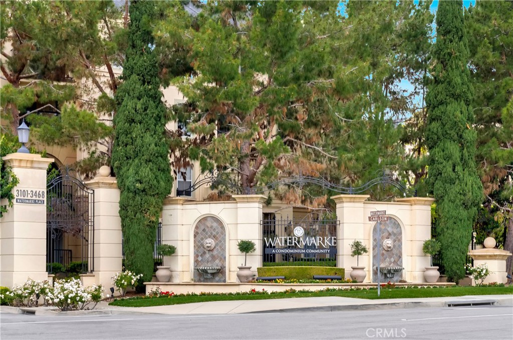 2459 Watermarke Place Irvine, CA 92612 - Photo 2 of 3 a front view of a house with a garden