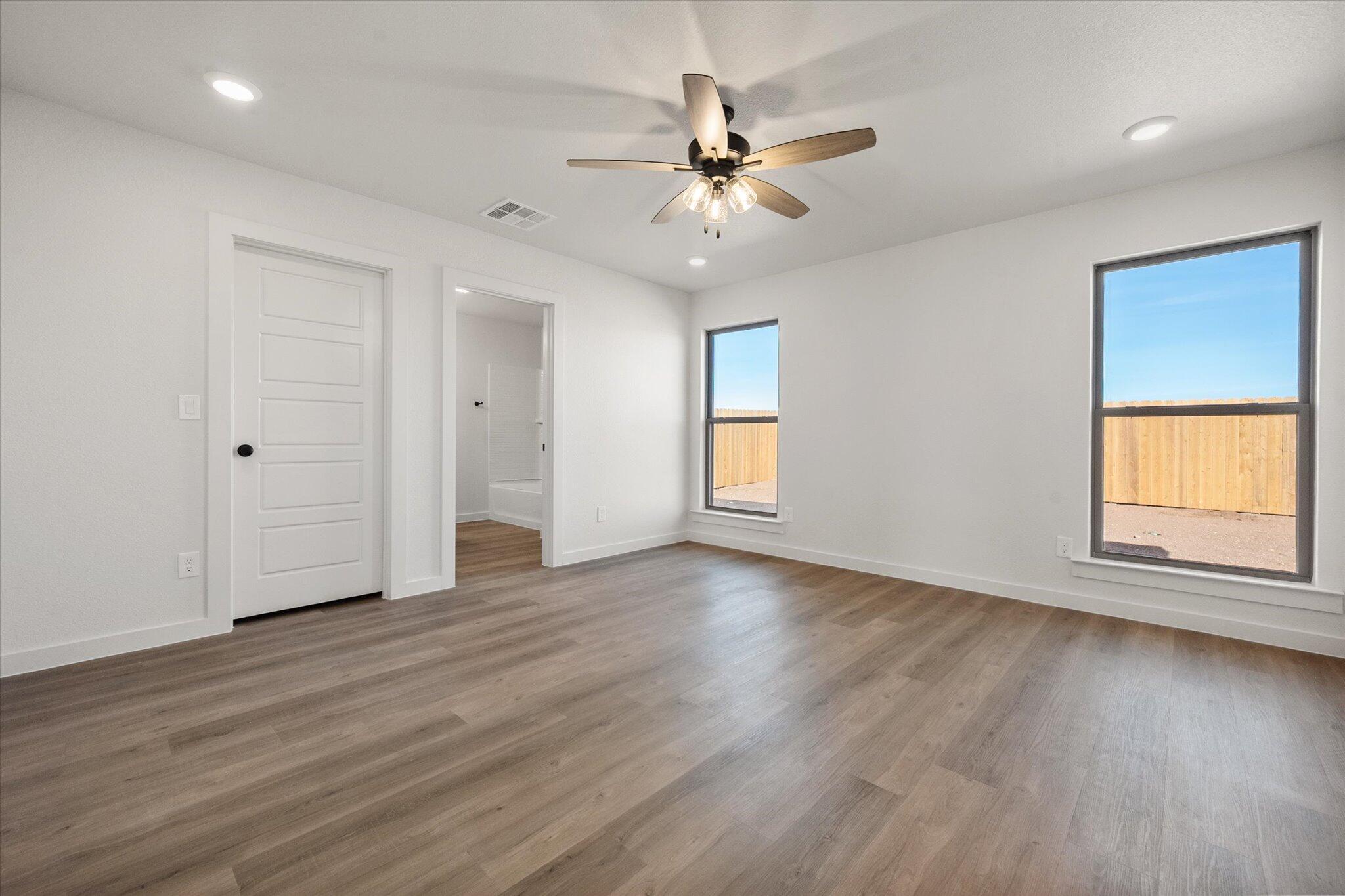 3108 138th Place Lubbock, TX 79423 - Photo 13 of 21 a view of an empty room with wooden floor and a window