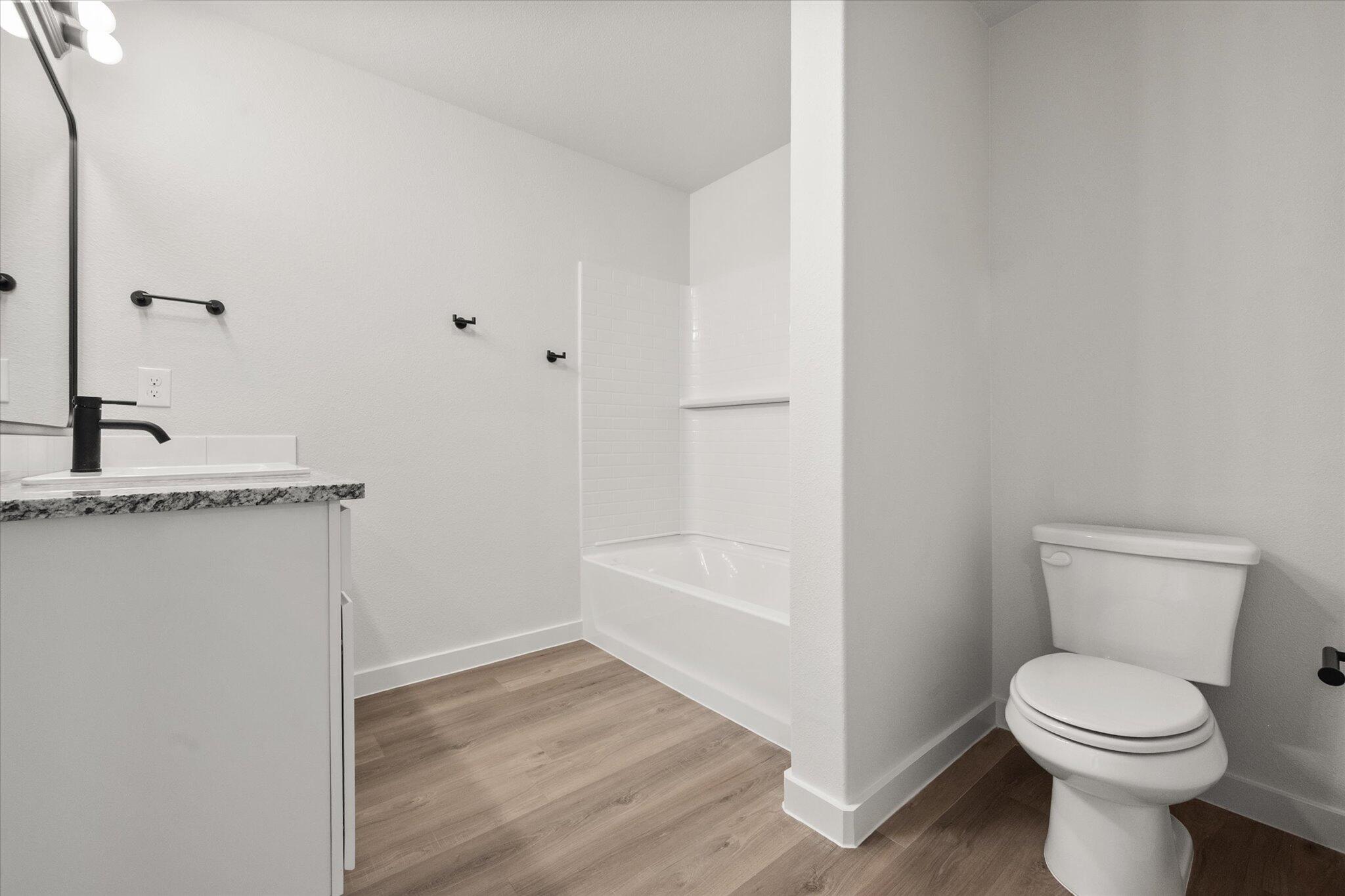 3108 138th Place Lubbock, TX 79423 - Photo 15 of 21 a bathroom with a toilet a sink and a bathtub