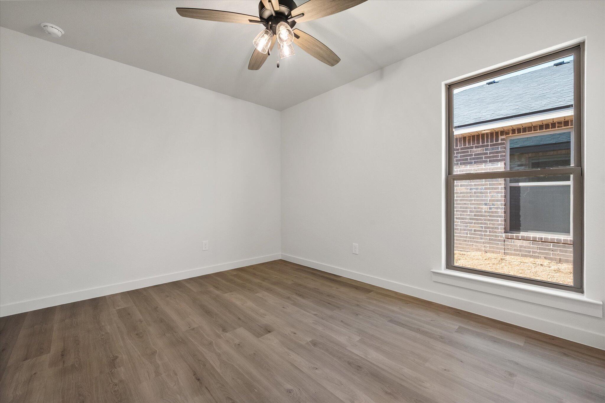 3108 138th Place Lubbock, TX 79423 - Photo 16 of 21 a view of an empty room with a window and closet area