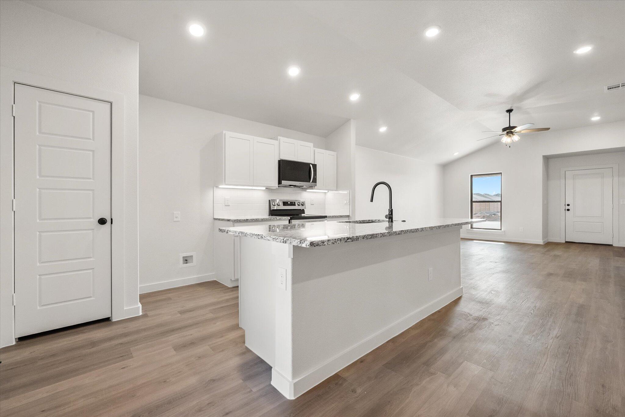 3108 138th Place Lubbock, TX 79423 - Photo 9 of 21 a view of kitchen with sink and wooden floor
