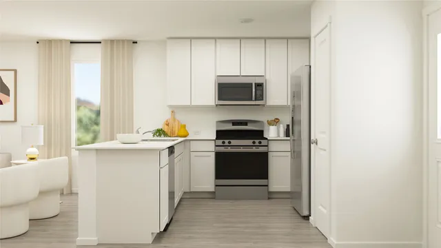 a kitchen with stainless steel appliances white cabinets and a refrigerator
