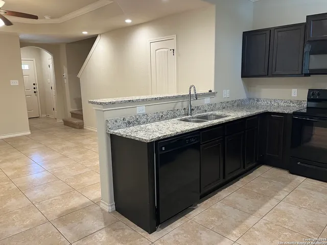 a kitchen with a sink and cabinets