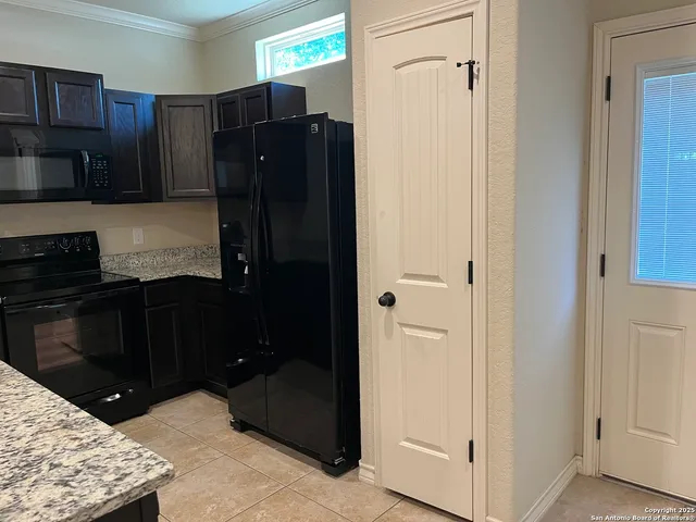 a kitchen with a refrigerator and a stove