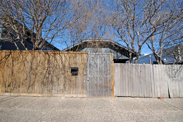 a front view of a house with a wooden fence